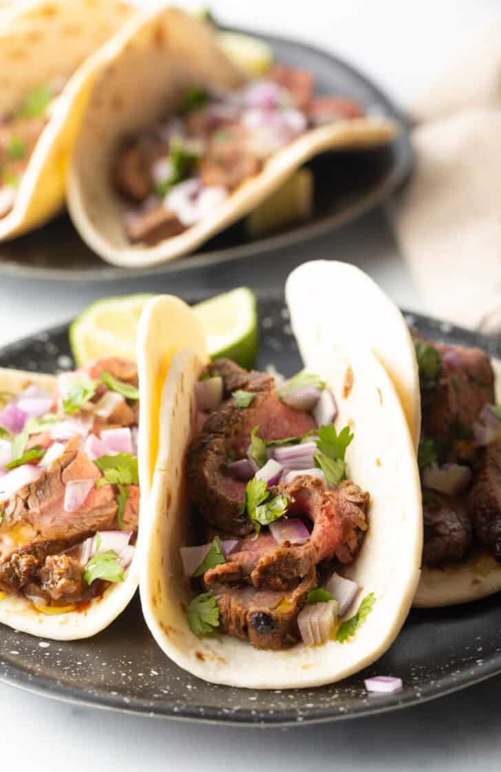 Close view of a steak taco with marinade.