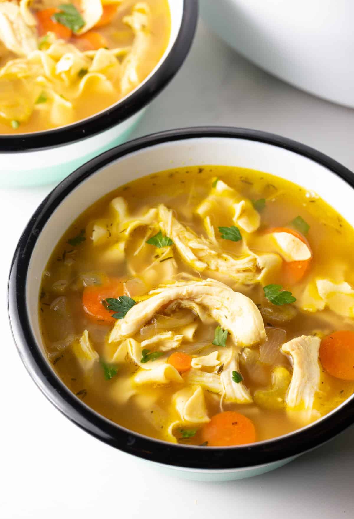 A bowl filled with homemade crockpot chicken noodle soup.