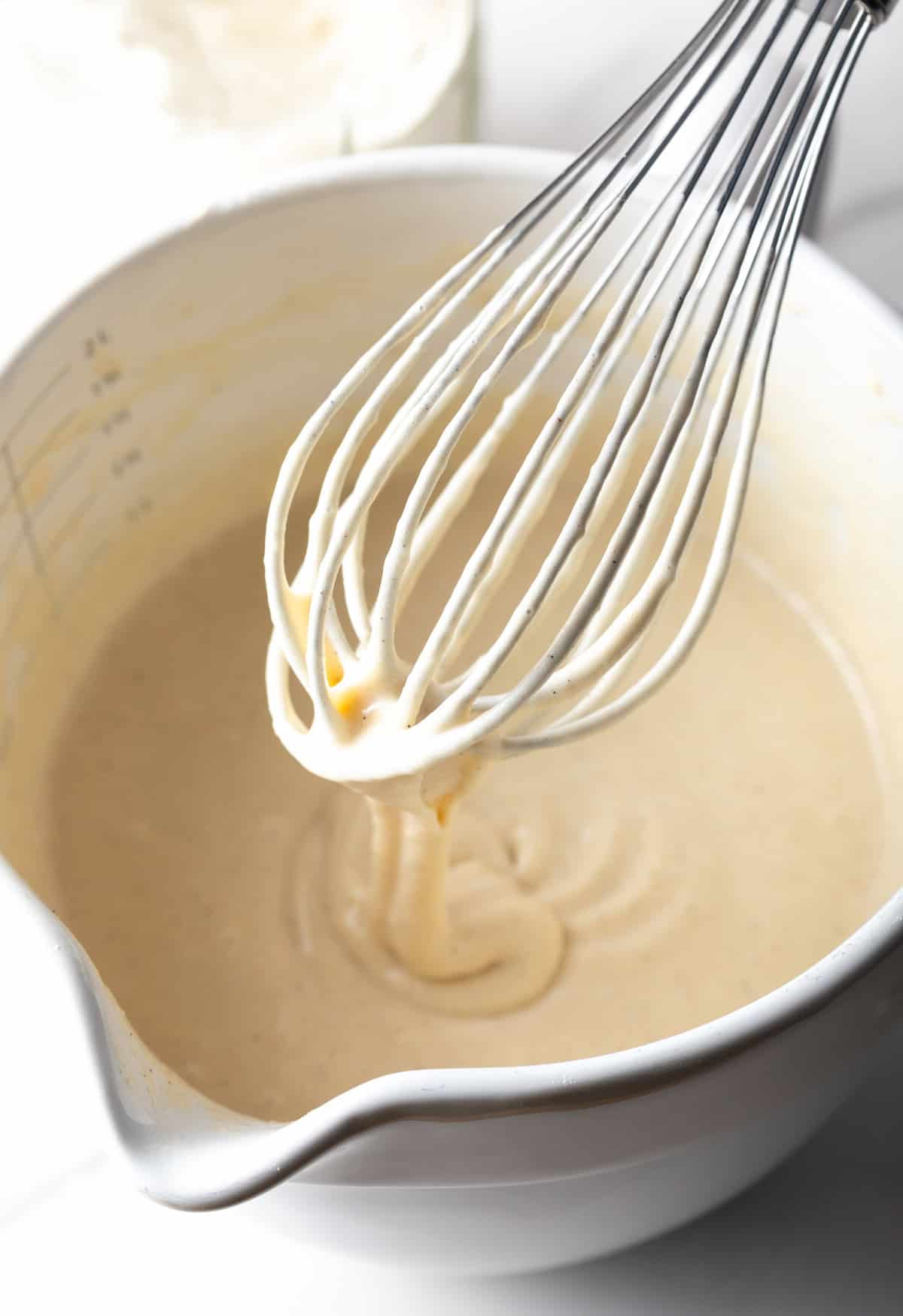 Homemade pancake mix being stirred with a whisk.