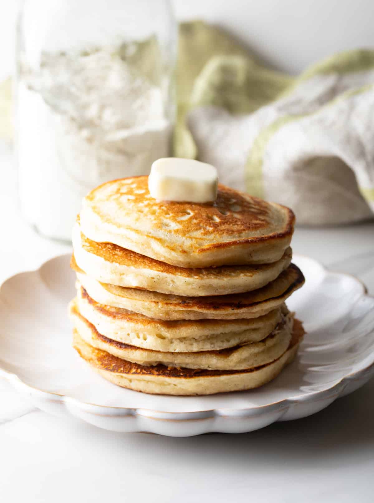 A fluffy stack of pancakes with butter on top, made with a homemade pancake mix recipe.