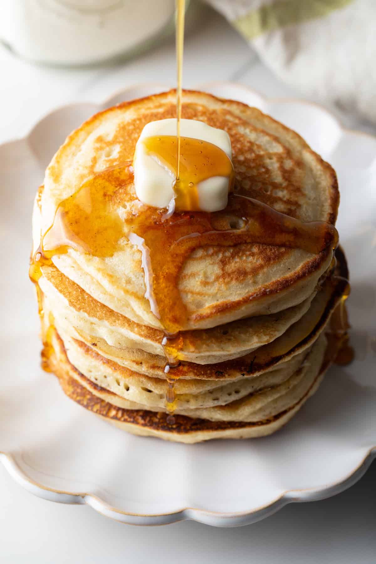 A fluffy stack of pancakes with butter and syrup, made with a homemade pancake mix recipe.