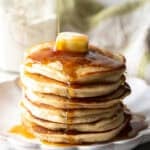 A fluffy stack of pancakes with butter and syrup, made with a homemade pancake mix recipe.