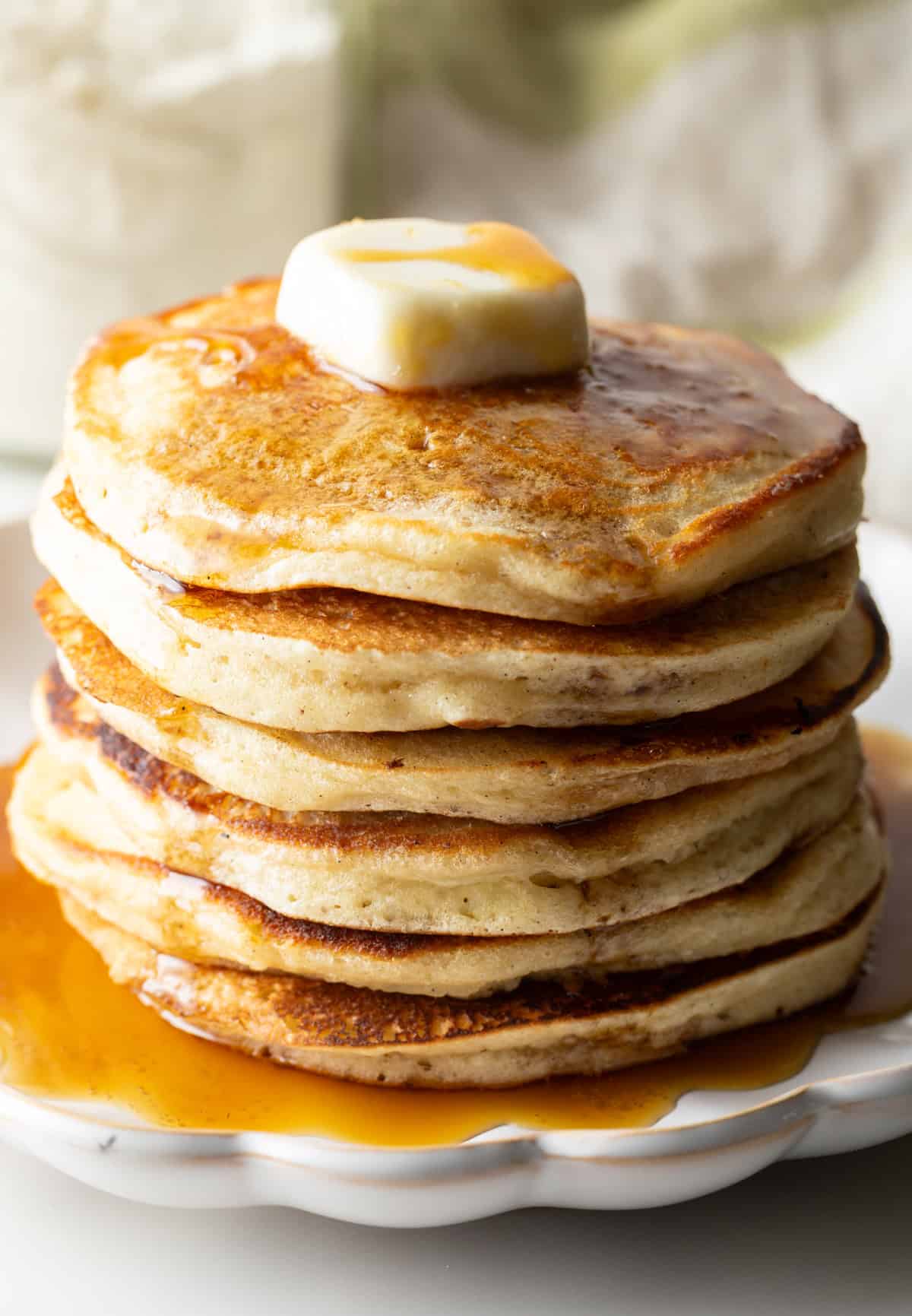 A fluffy stack of pancakes with butter and syrup, made with a homemade pancake mix recipe.