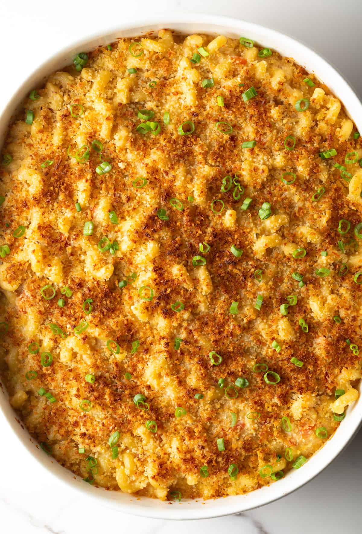 Overhead shot of Cajun mac and cheese with crispy baked topping in a white baking dish.