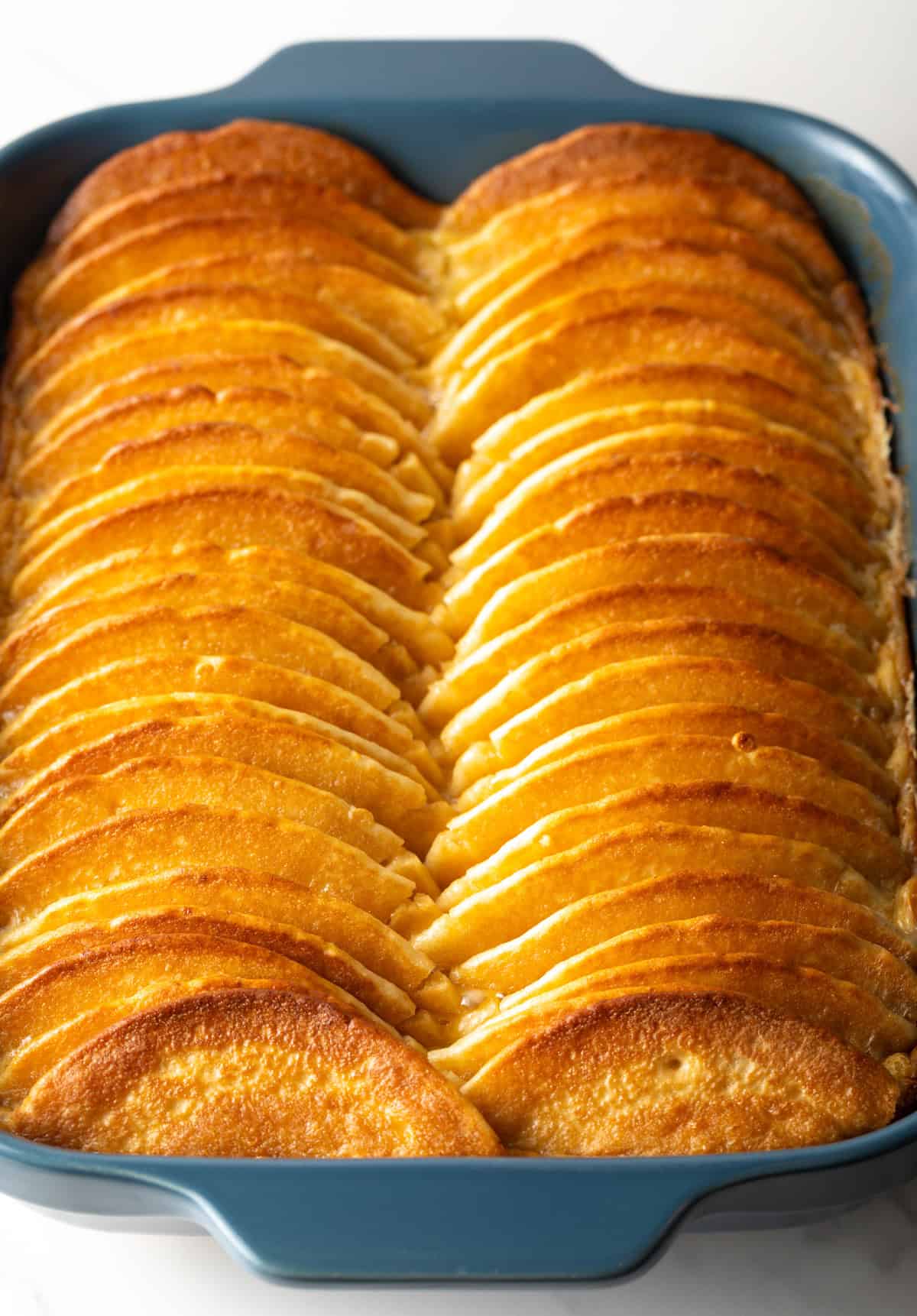 Baked pancake breakfast casserole in a blue baking dish, fresh from the oven.