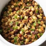 Overhead shot of crock pot stuffing recipe in a white crock pot.