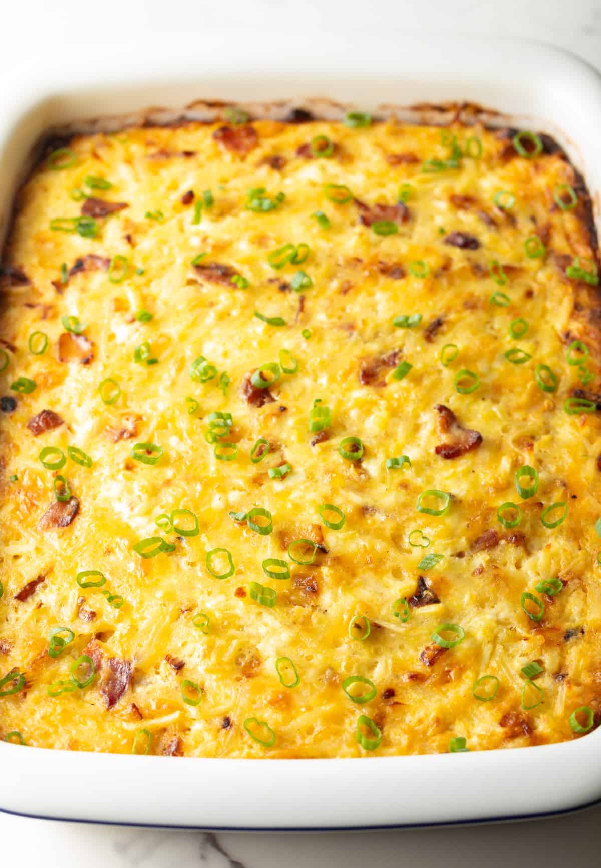 White rectangle baking dish with baked Amish breakfast casserole.