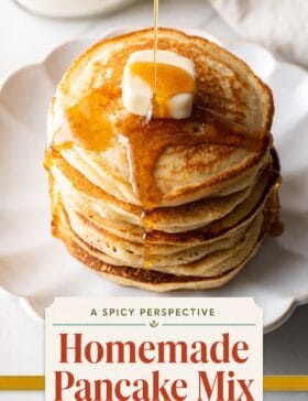 Single-image poster with warm golden (#D8B412) and deep red (#B9412C) tones, teal (#67B0AB) accent, and olive (#89883C) text block showcasing a tall stack of fluffy homemade pancakes.
