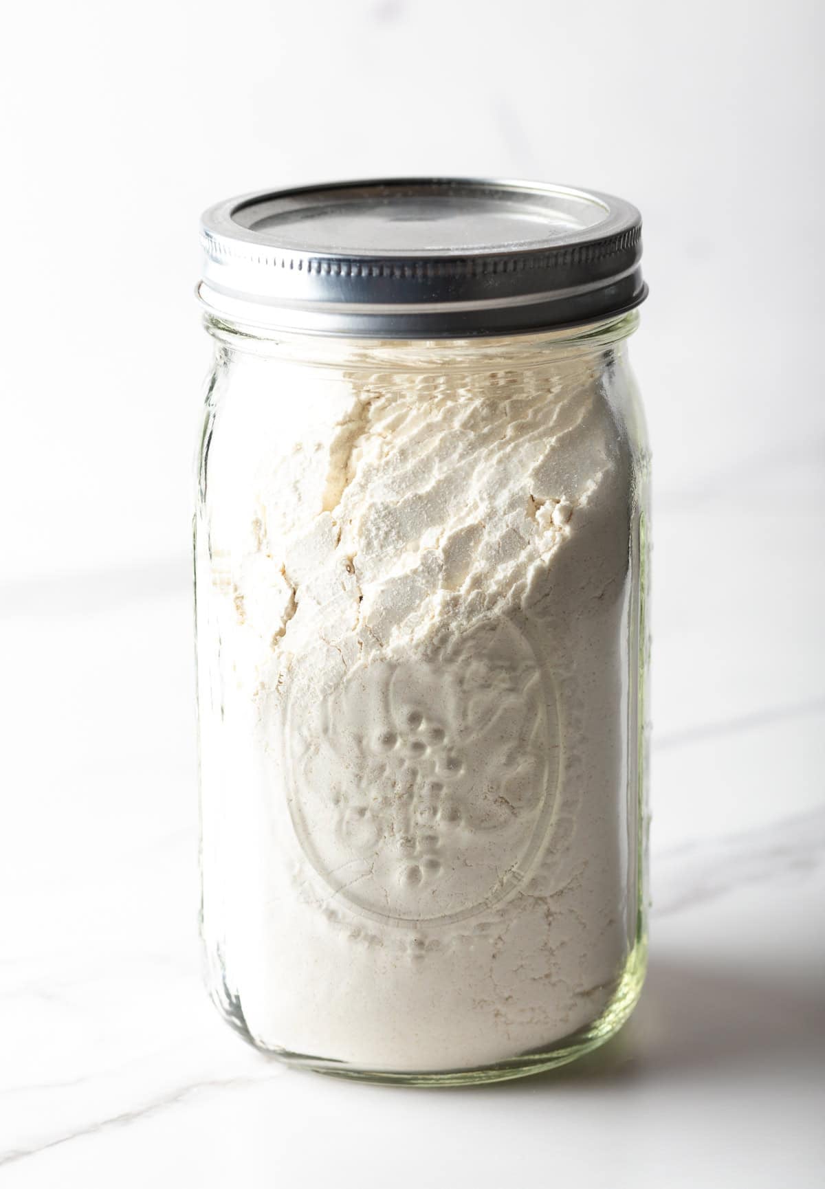 A mason jar filled with buttermilk pancake mix.