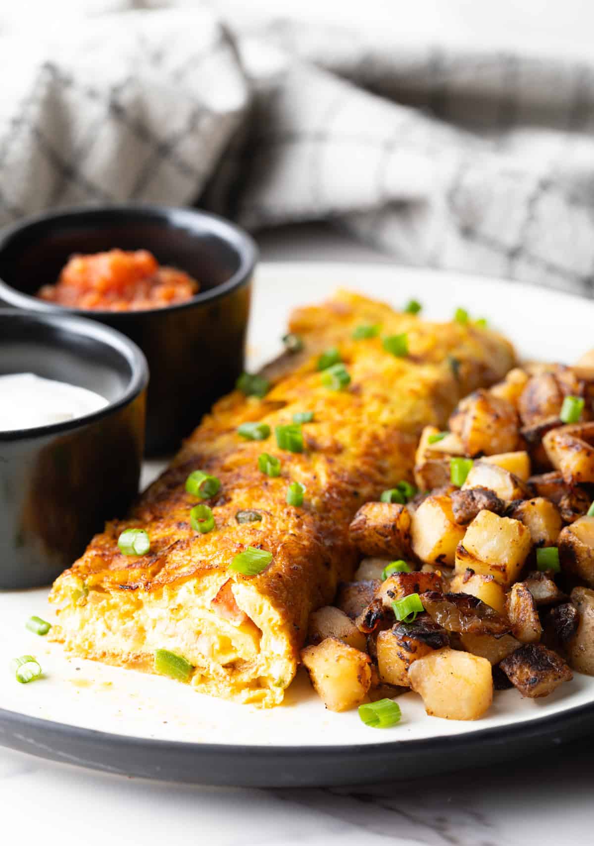 A Denver omelette recipe with a slice taken out, showing you the inside of the omelette.