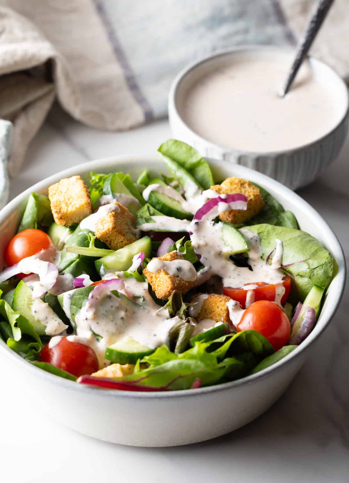 A fresh garden salad topped with a homemade Parmesan peppercorn salad dressing.
