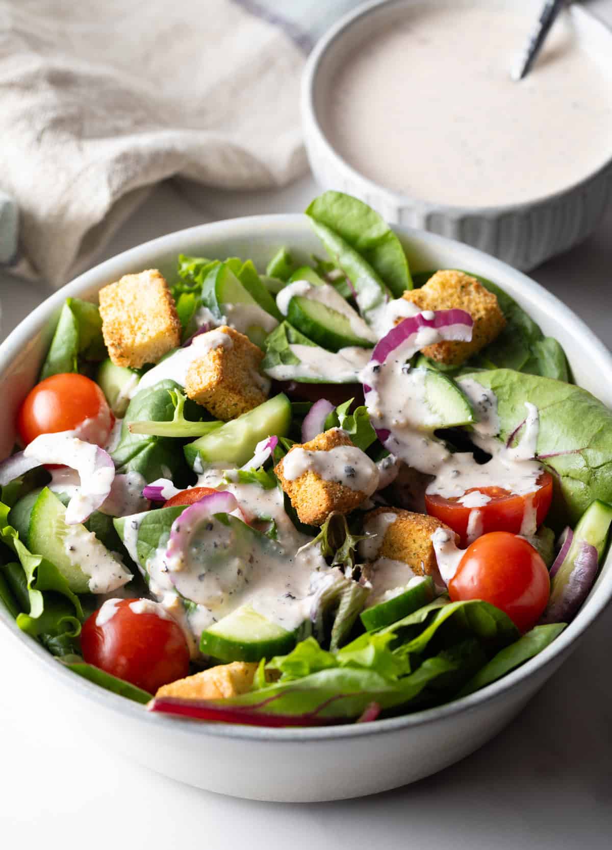 A fresh garden salad topped with a homemade Parmesan peppercorn dressing.