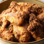 Crispy homemade southern fried chicken pieces in a bowl.