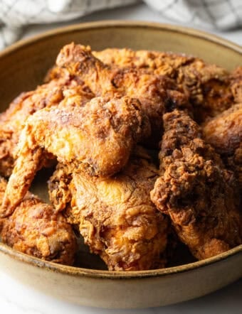 Crispy homemade southern fried chicken pieces in a bowl.