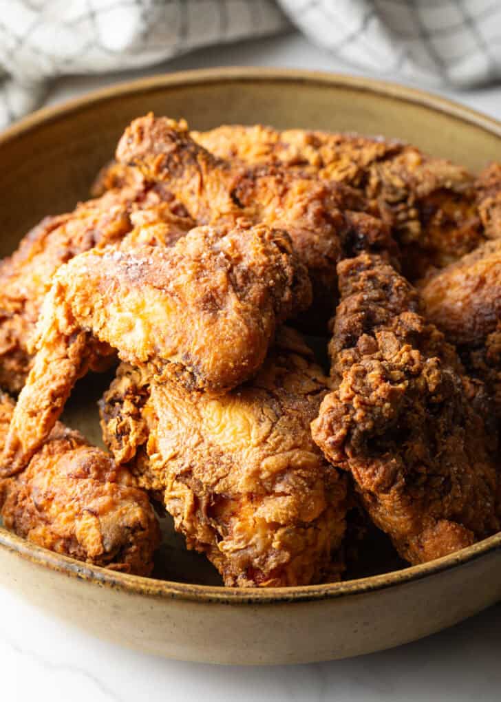 Crispy homemade southern fried chicken pieces in a bowl.