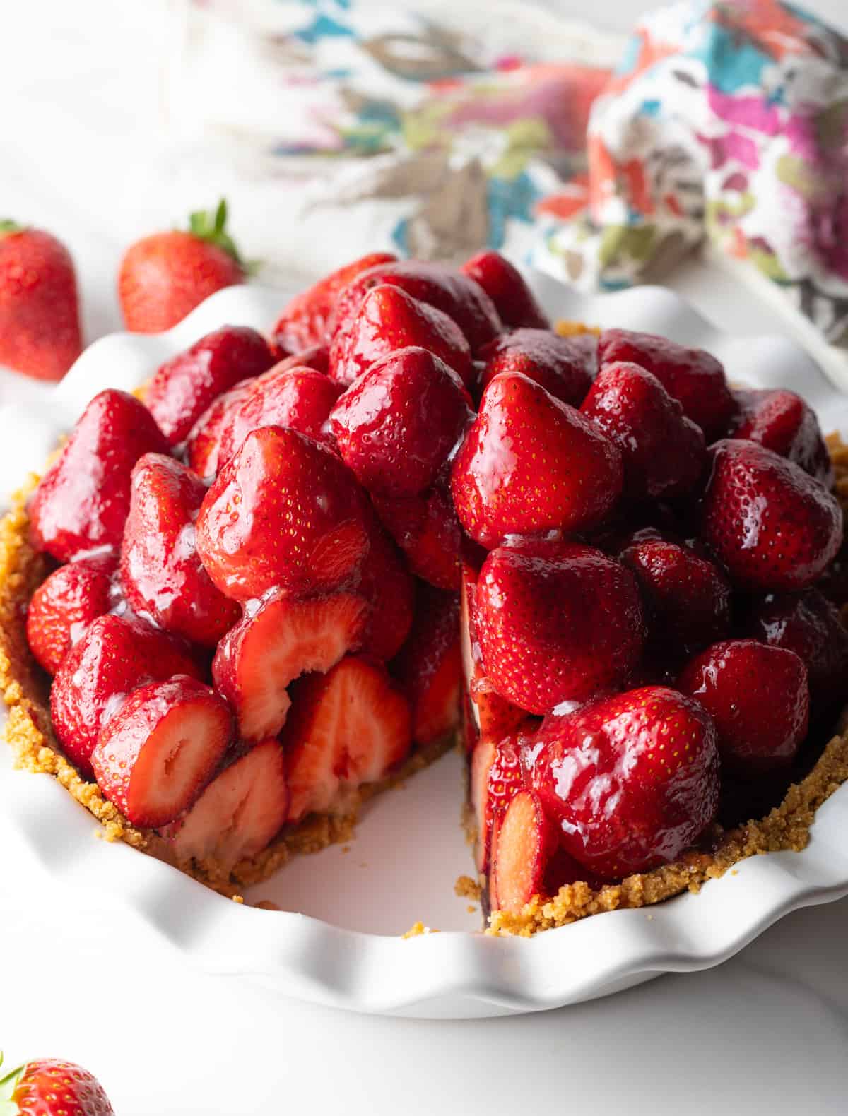 Strawberry pie in a plate, with one slice removed.