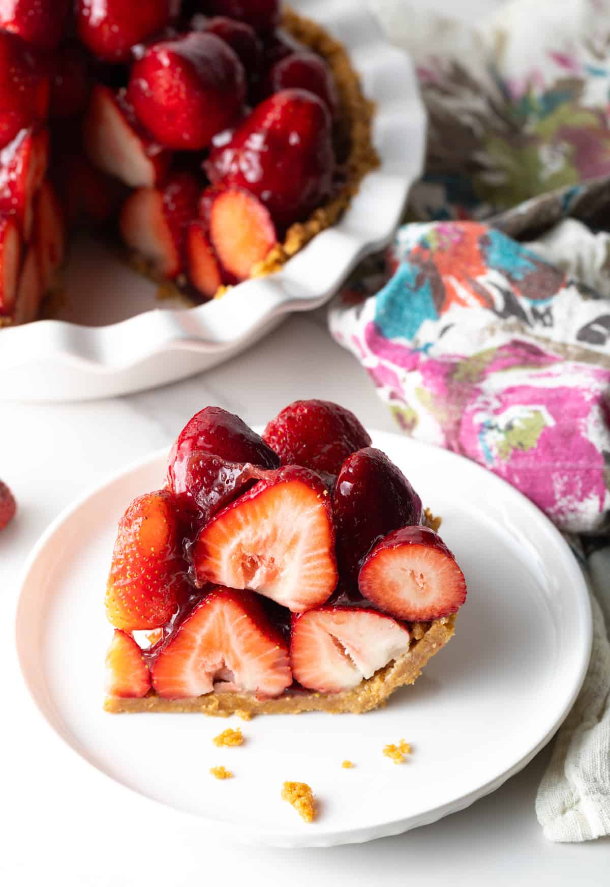 Slice of strawberry pie on a white plate.