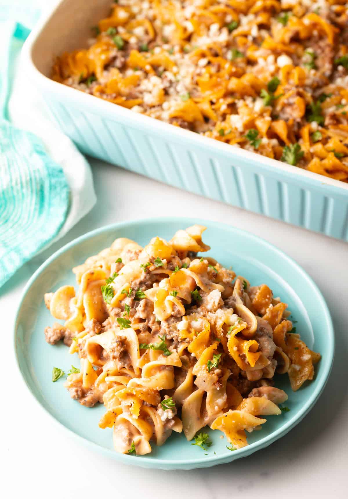 Serving of amish casserole on a blue plate.
