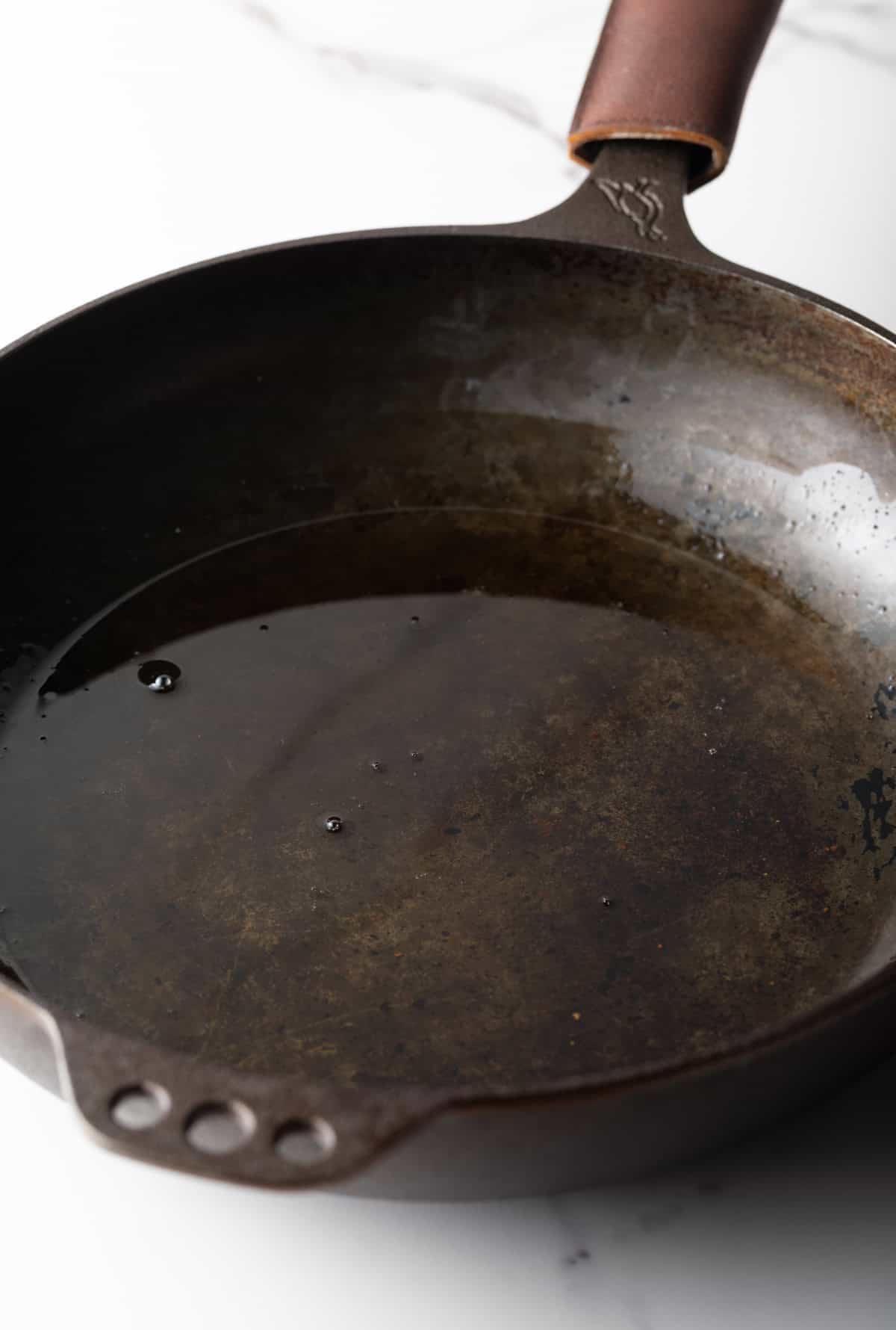 A black skillet filled with bacon grease.