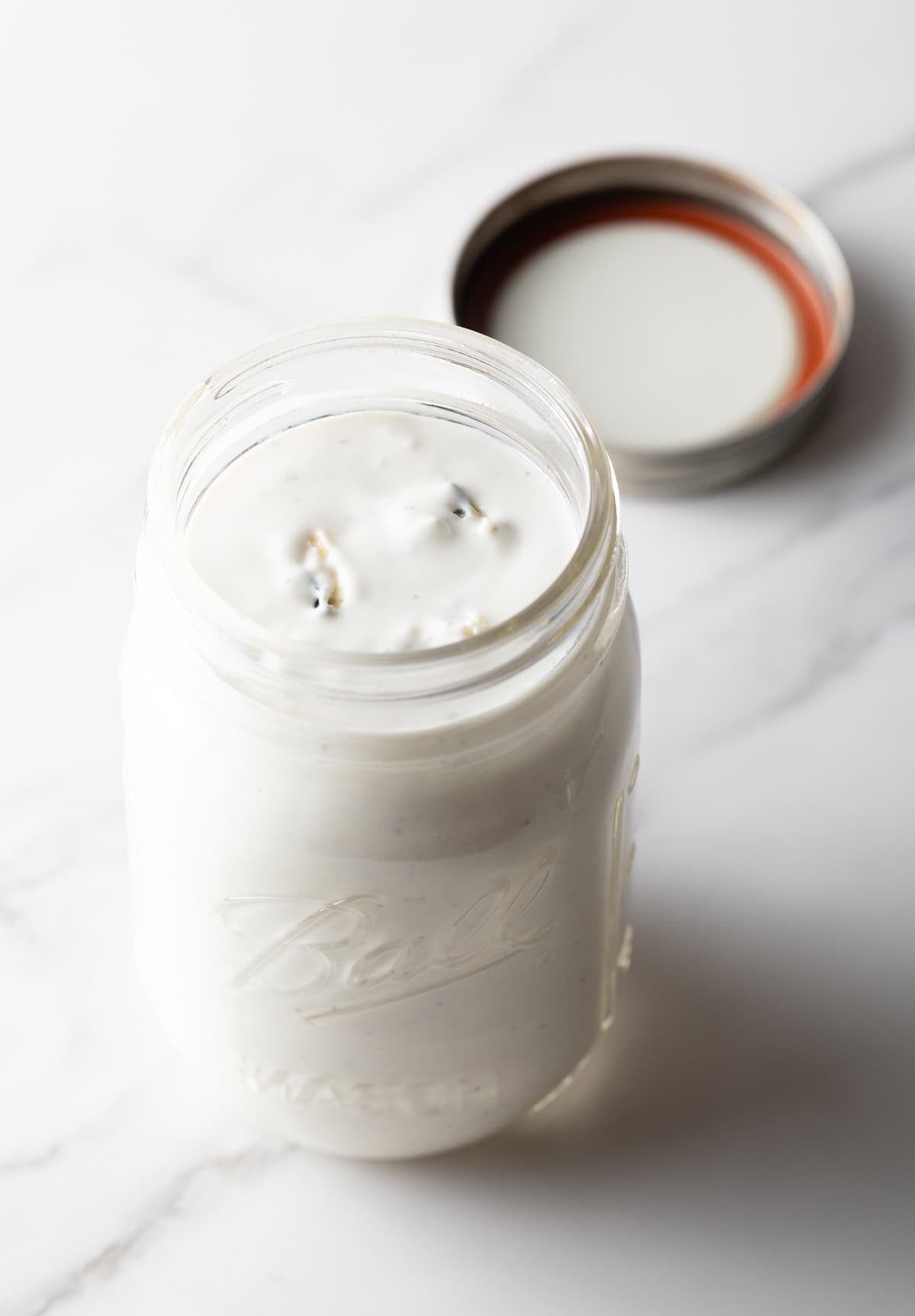 A glass jar filled with the best blue cheese dressing recipe.