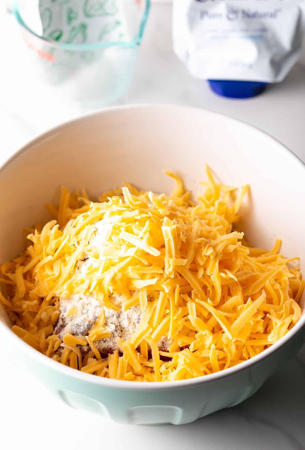 All of the ingredient to make cracker burgers in a white bowl.