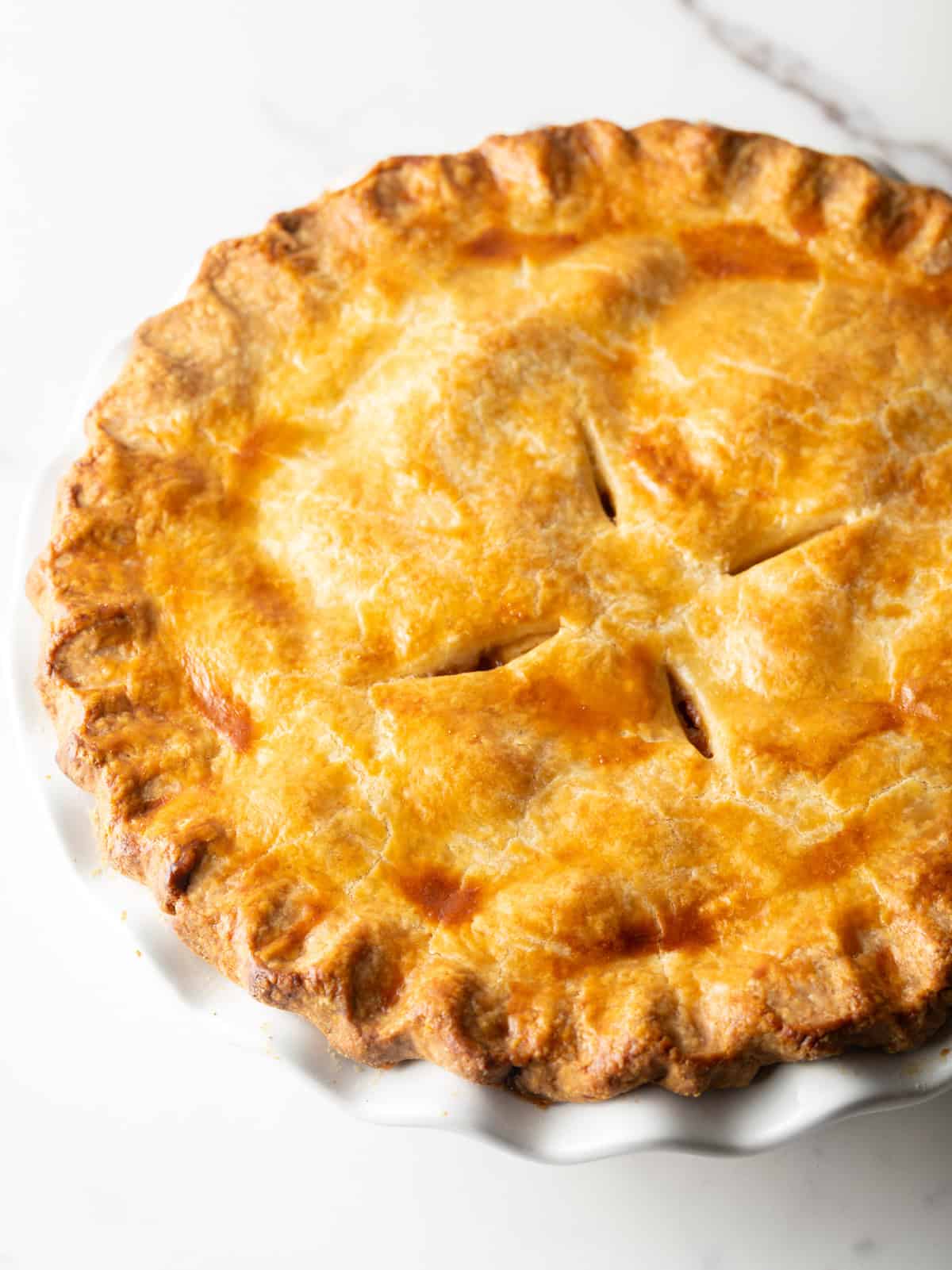 An overhead shot of a full homemade apple pie recipe.