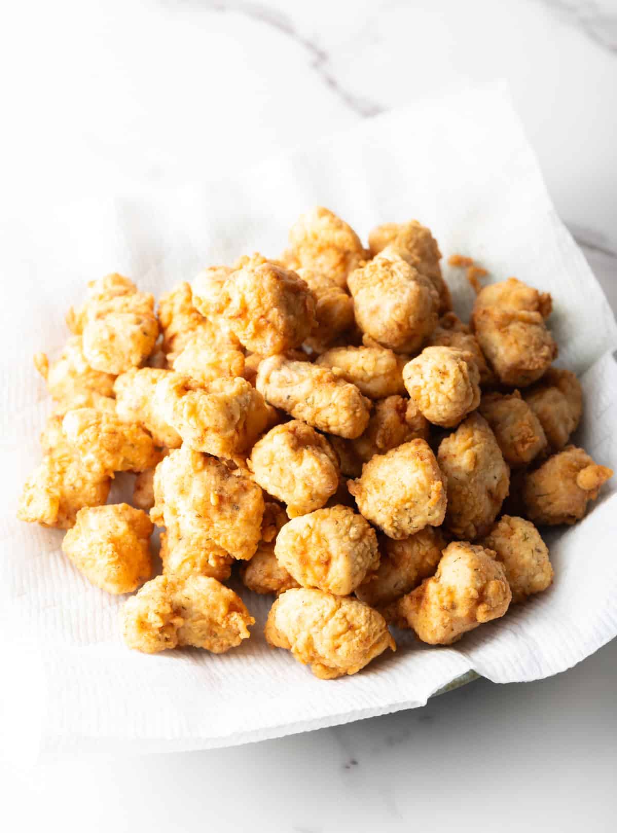 A paper-lined bowl filled with a crispy fish nuggets recipe.