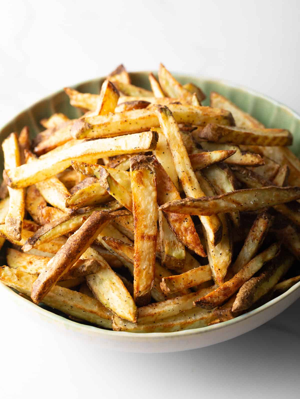 Fries in a white bowl.
