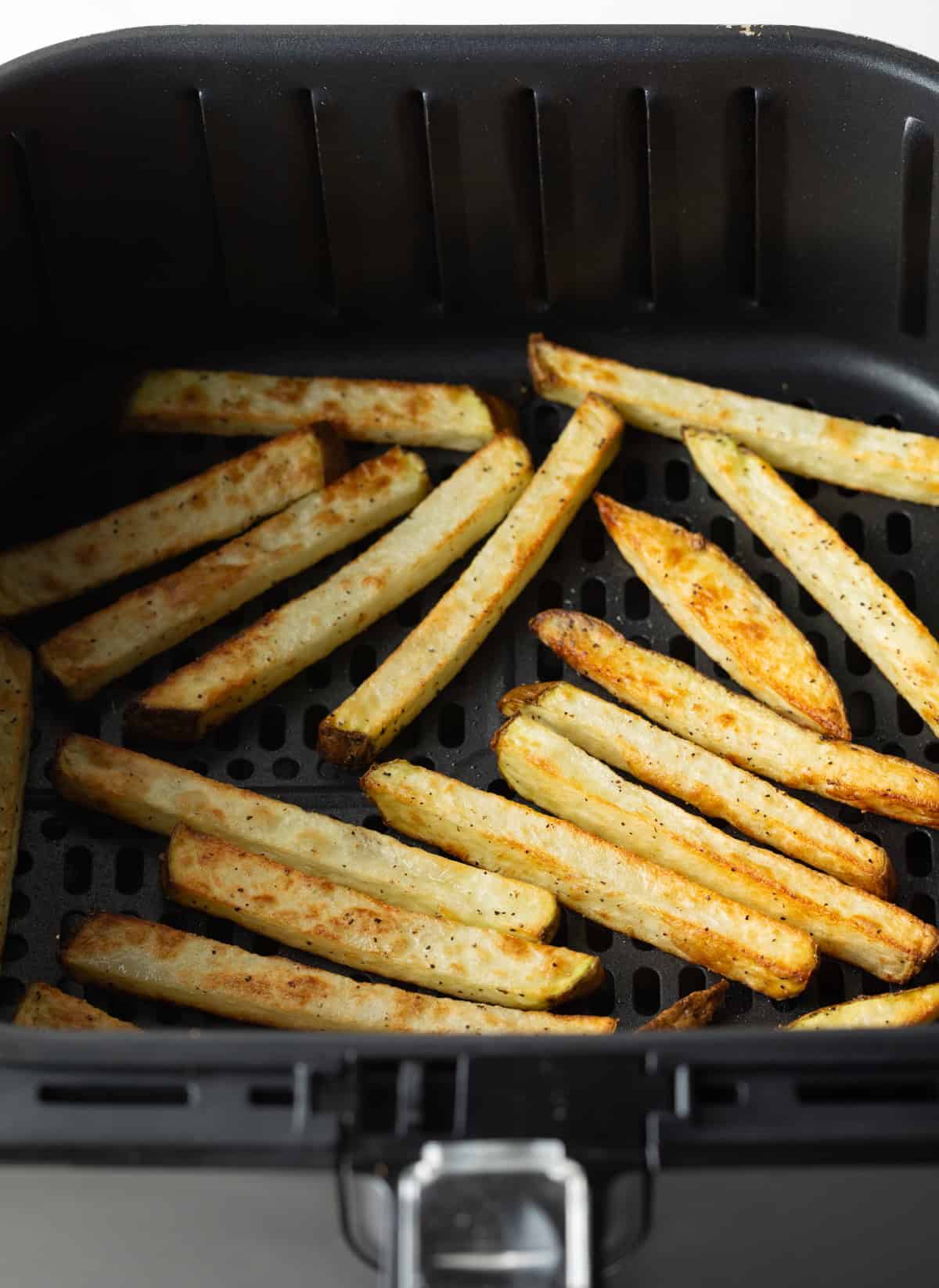 Flip the fries in the air fryer.