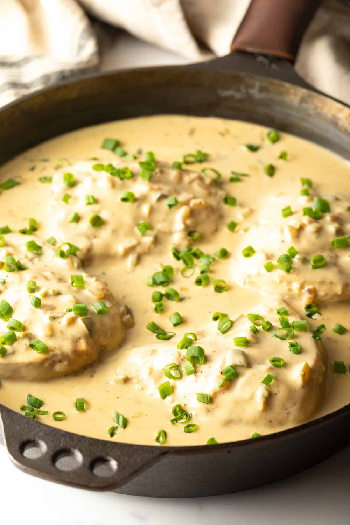 A black skillet filled with a creamy jalapeno chicken recipe.