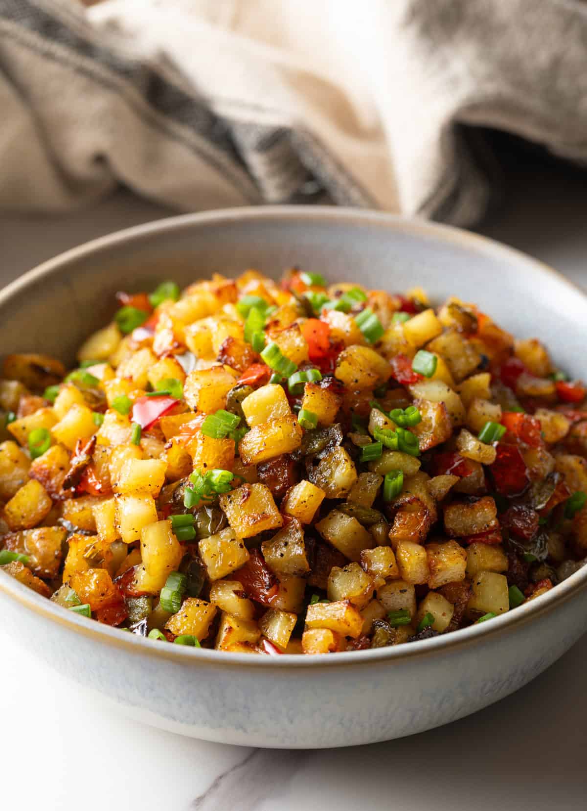 A bowl filled with a homemade potatoes O'brien recipe.