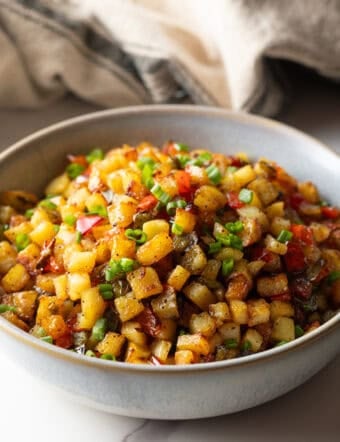 A bowl filled with a homemade potatoes O'brien recipe.