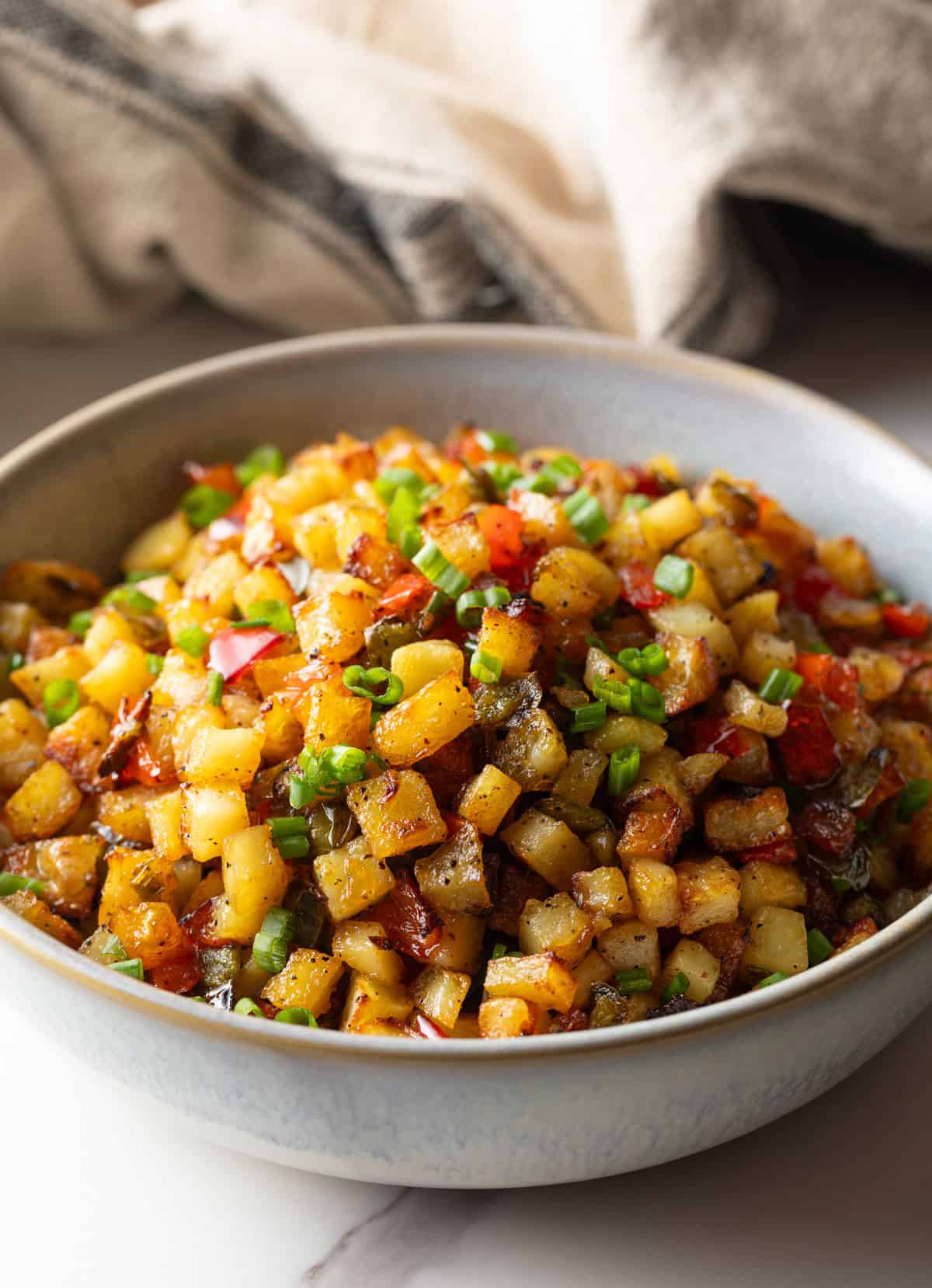 A bowl filled with a homemade potatoes O'brien recipe.