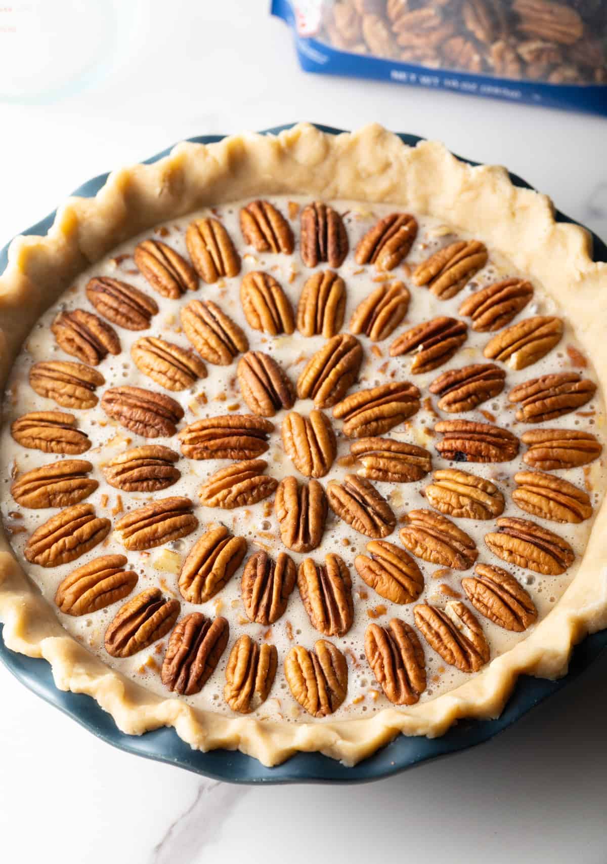 A fully assembled pecan pie ready for baking.