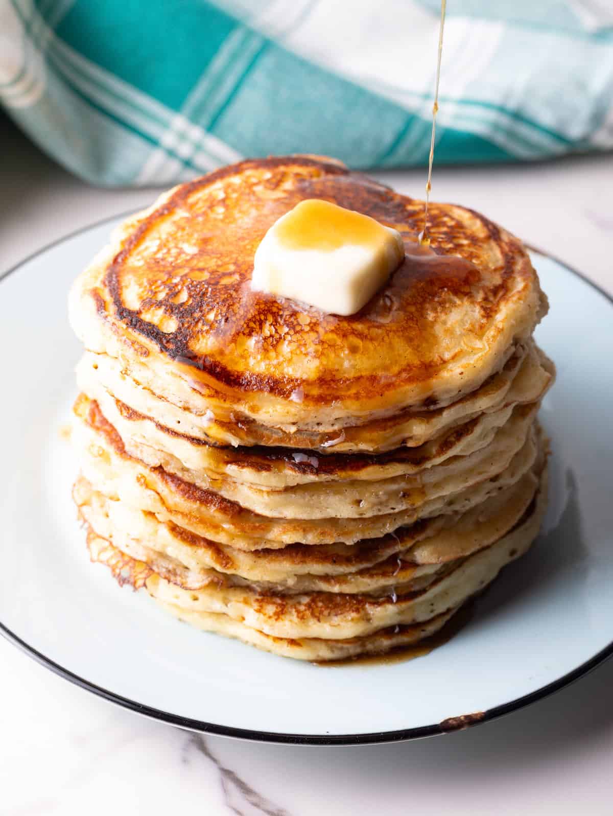 easy buttermilk pancakes with maple syrup poured over the top.