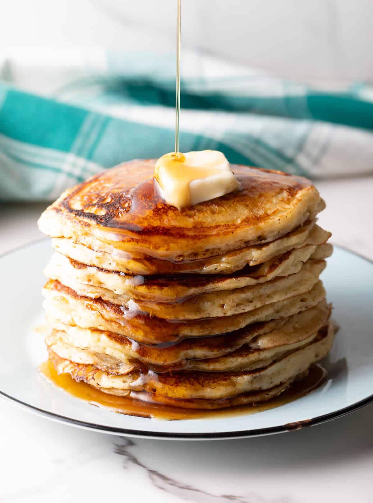 hotcakes with maple syrup poured on top