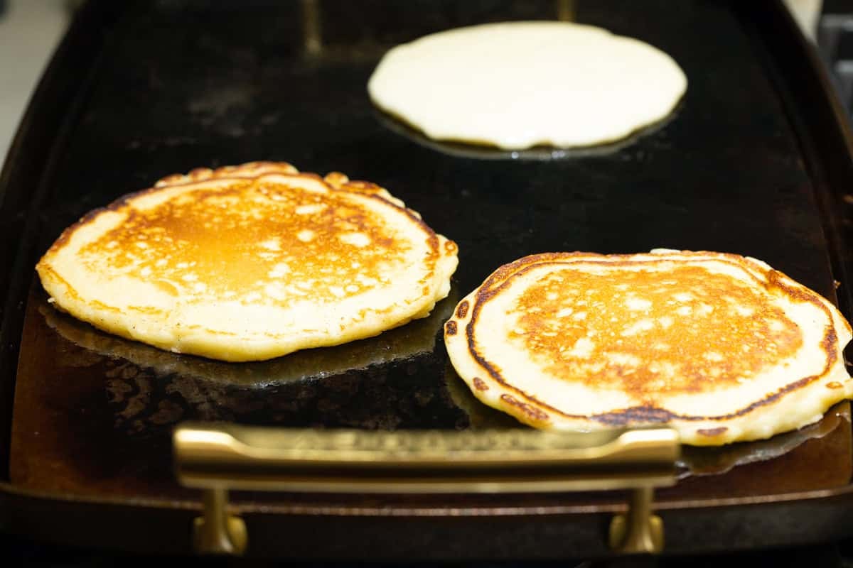 buttermilk pancakes on a hot buttered griddle