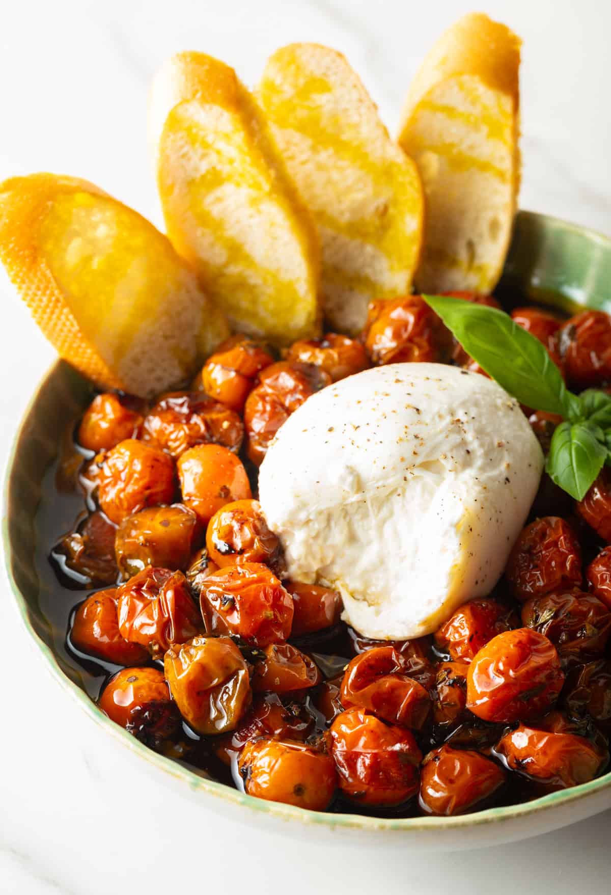 easy roasted tomatoes in bowl with toasted bread