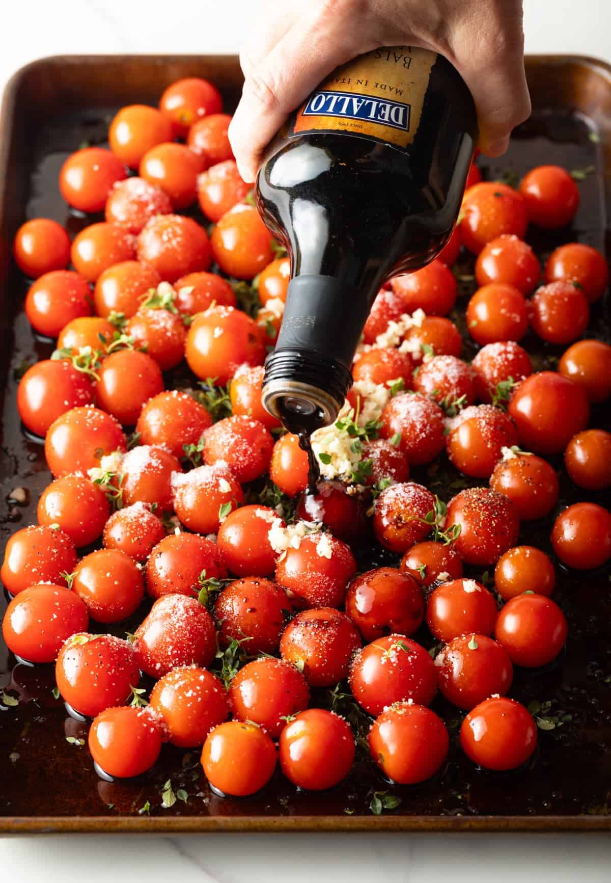 balsamic vinegar poured over cherry tomatoes