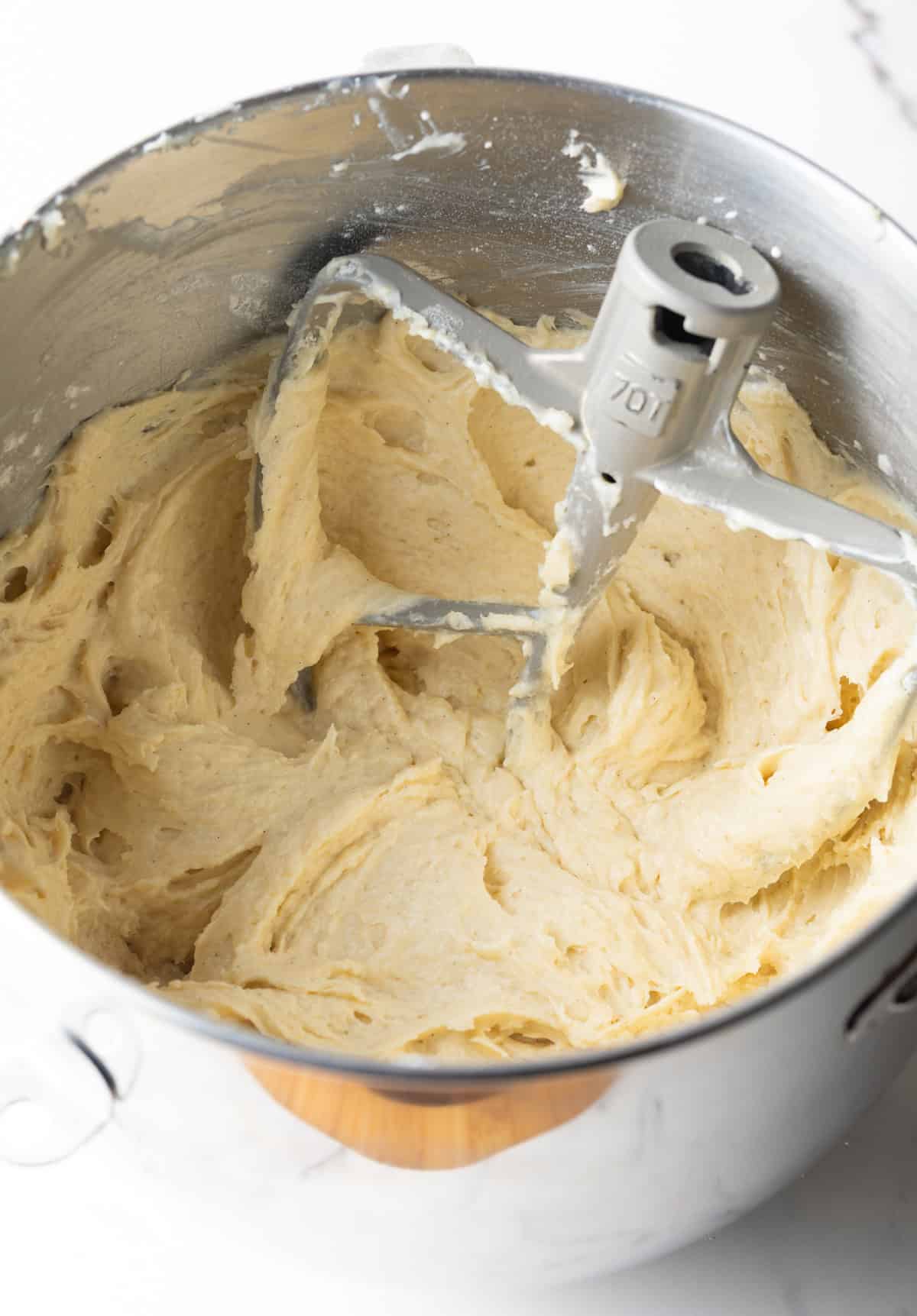 A batter for easy cinnamon coffee cake is being mixed in an electric mixer.